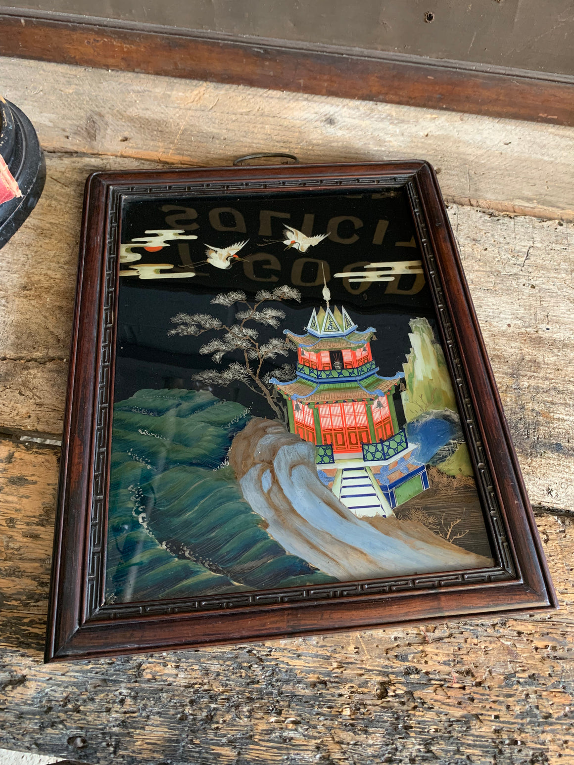 A large reverse painted glass pagoda picture