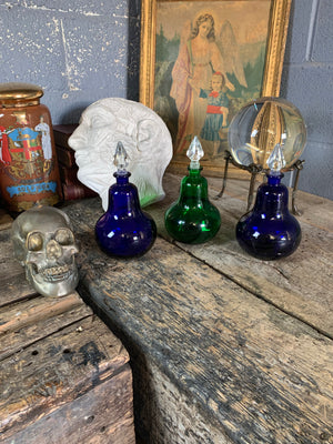A trio of coloured glass apothecary jars