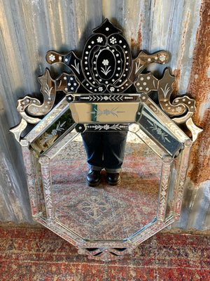 A large Venetian style cushion mirror