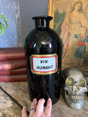 A pair of very large amethyst glass apothecary bottles
