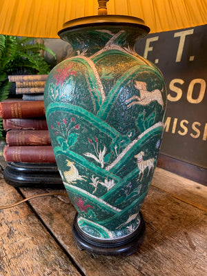 An Oriental green ceramic lamp on a hardwood stand