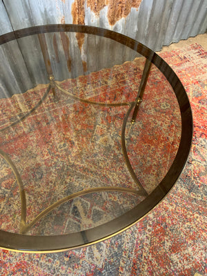 A rare circular brass and glass Hollywood Regency coffee table