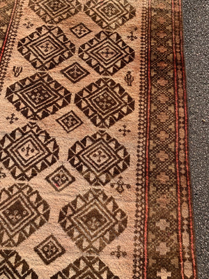 A large rectangular brown ground Persian rug