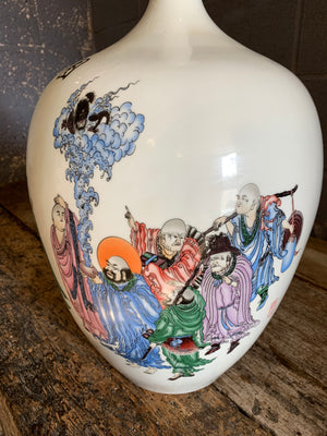 A large white Chinese porcelain vase depicting the Eighteen Arhats