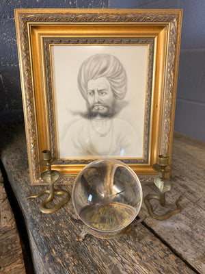 A fortune teller's crystal ball on a bronze stand