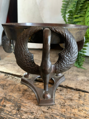 A large fortune teller's crystal ball on a bronze stand