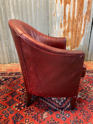 An oxblood leather tub chair