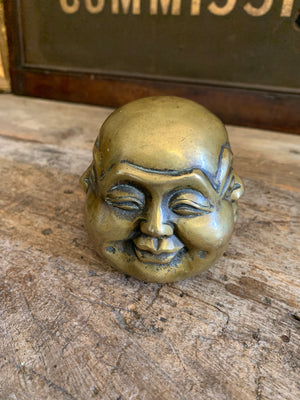 A trio of Asian bronze four faced Buddha heads