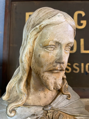 A plaster bust of Jesus with flaming Sacred Heart