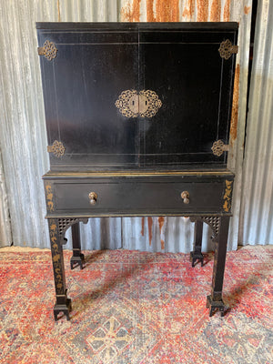 An ebonised Chinoiserie fitted cabinet on stand