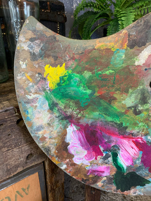 A large abstract artwork on an artist's palette