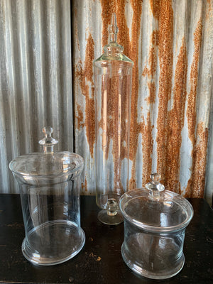 A collection of three large glass apothecary jars
