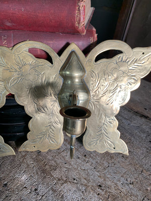 A pair of large brass butterfly wall sconces