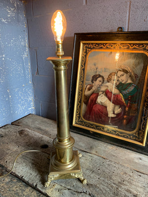 A brass column table lamp with lion paw feet