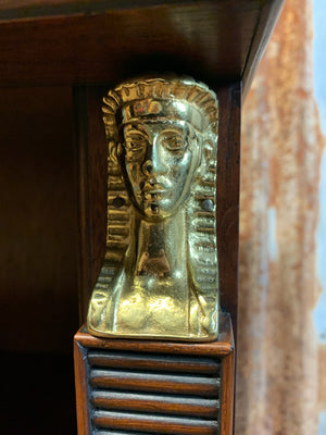 An empire style bookcase with Egyptian motifs