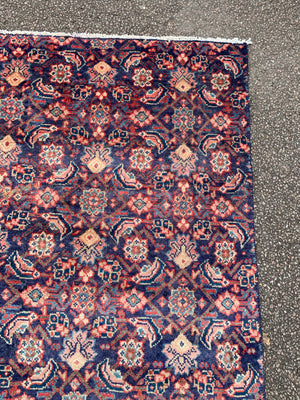 A large Persian blue ground rectangular rug