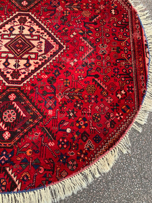 An unusual circular red ground Persian rug- 196cm