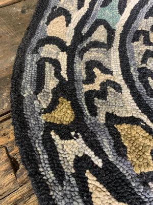 A woollen coiled serpent rug
