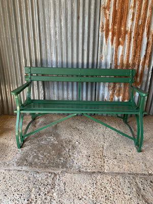 A green cast iron and wooden garden bench
