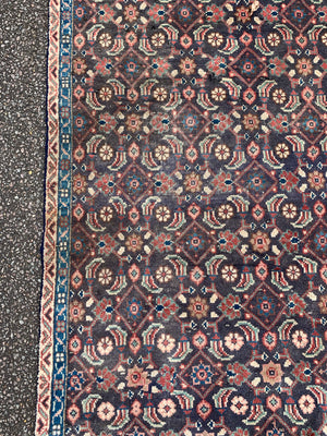 A Persian blue and brown ground rectangular rug