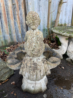 A cast stone bird bath with the figure of a fawn