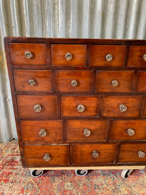 A very large bank of 45 graduated apothecary drawers