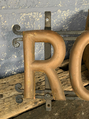 A wrought iron ROBINSON name trade sign