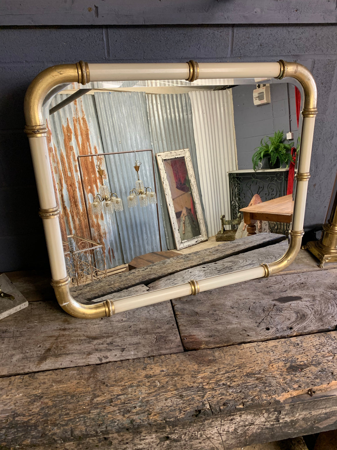 A large cream and gold Hollywood Regency wall mirror