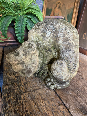 A very old lion chimera garden statue
