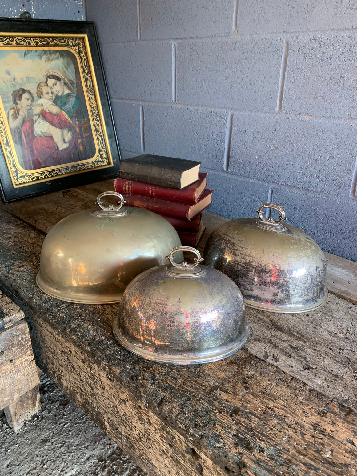 A trio of graduated silver plate meat cloches by Walker & Hall