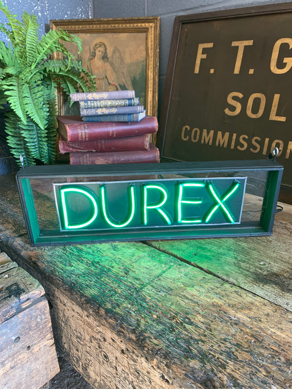 An illuminated Durex sign - Belle and Beast Emporium