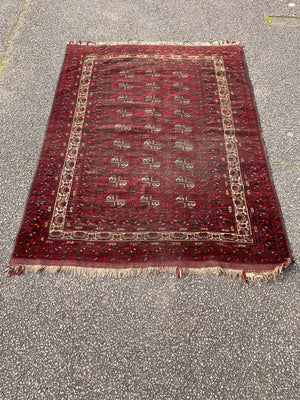 A Persian red ground Bokhara rug - 191 x 136cm