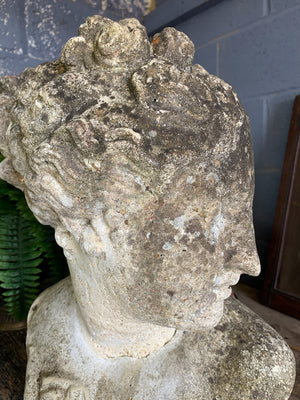 A weathered cast stone bust of Venus or Aphrodite