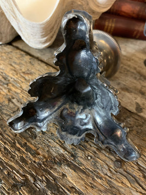 A fortune teller's crystal ball on a silver plated dolphin stand