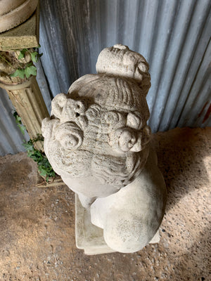 A cast stone bust of Venus (or Aphrodite) on a pedestal