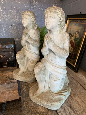 A pair of praying child angel garden statues in cast stone