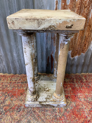 A faux marble neoclassical pedestal stand