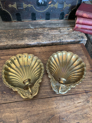 A pair of very large brass shell candlestick wall sconces