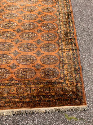 A very large gold ground Bokhara rug