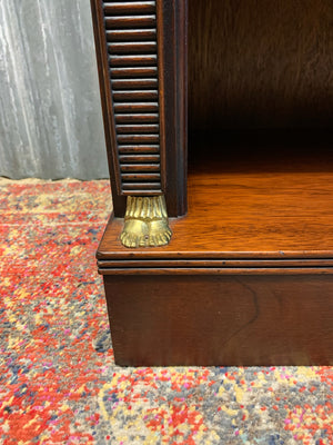 An empire style bookcase with Egyptian motifs