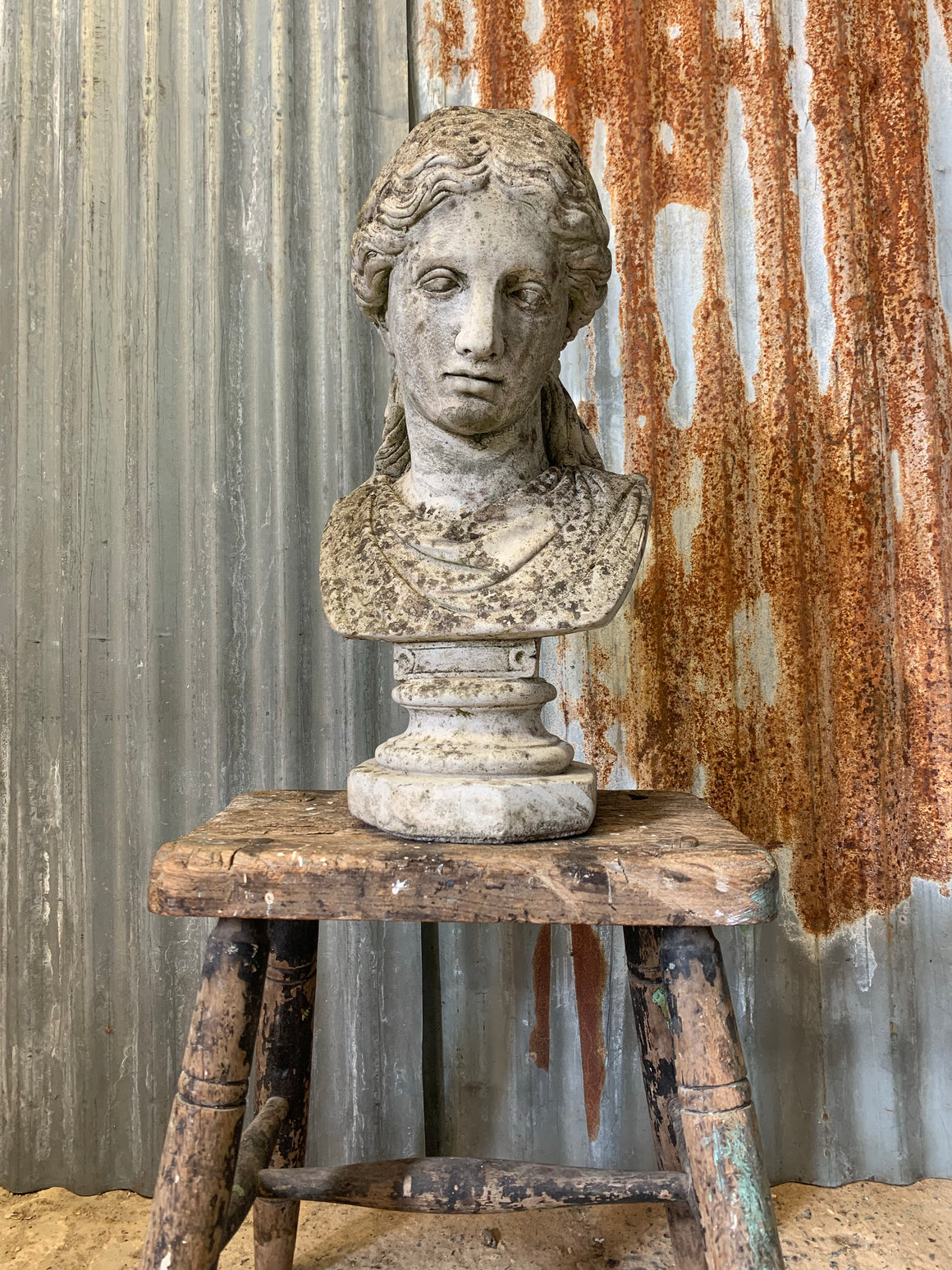A cast stone classical female bust