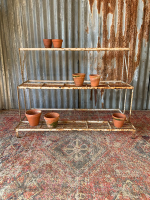 A white cast iron plant stand