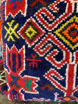 A rectangular red ground Persian carpet floor cushion