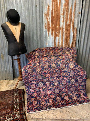 A large Persian blue ground rectangular rug