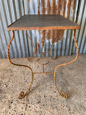 A twisted wrought iron garden table