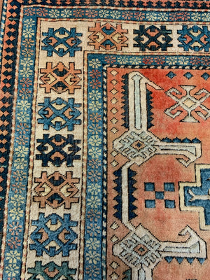 An orange and blue rectangular Persian rug