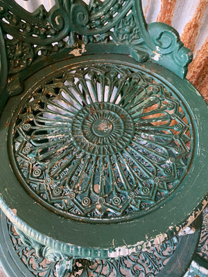 A green garden table and chairs set