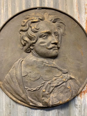 A metal roundel relief plaque of a gentleman