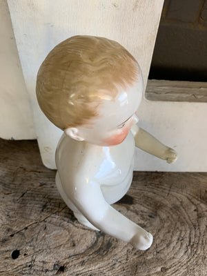 A 19th Century porcelain frozen Charlie doll