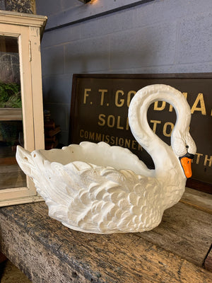 A very large faux stone swan planter